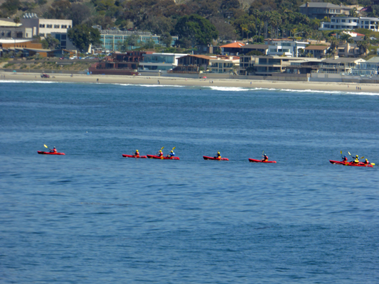 Red kayaks yellow paddles