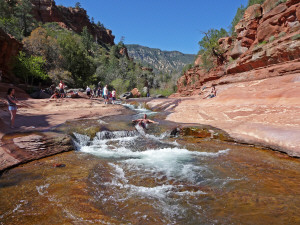 People going down shoot at Slide Rock Oak Creek Canyon Sedona AZ