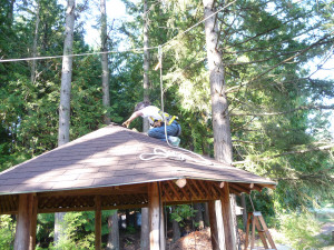 Sara Schurr putting last shingle on gazebo roof