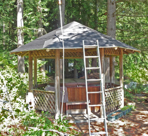 Roofing felt on and posts trimmed on gazebo