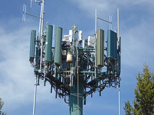 Repairman working on cell tower