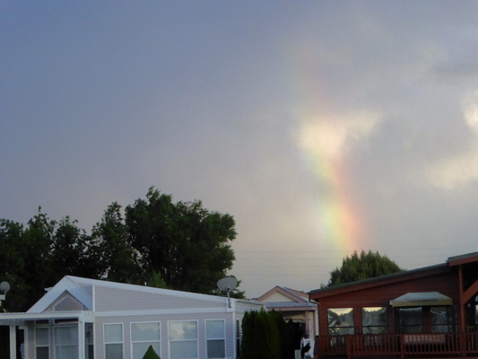 Rainbow disappearing into clouds