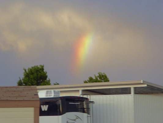 Rainbow disappearing into clouds