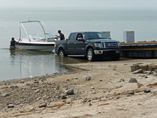 Putting boat on trailer with low water at ramp