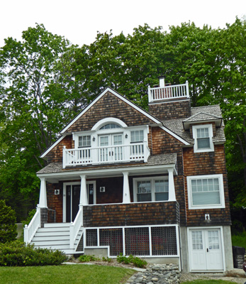 Brown shingle house with widows walk