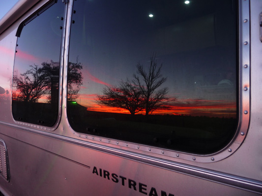 Sunset reflected in Genevieve Airstream's windows