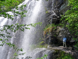 Walter Cooke standing under Silver Falls along the Silver Falls Trail WA