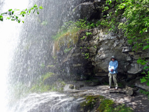 Walter Cooke standing under Silver Falls along the Silver Falls Trail WA