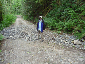 Walter Cooke with washout area of road/trail to Sunset Mine NE of Index WA