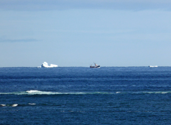 2 icebergs and fishing boat
